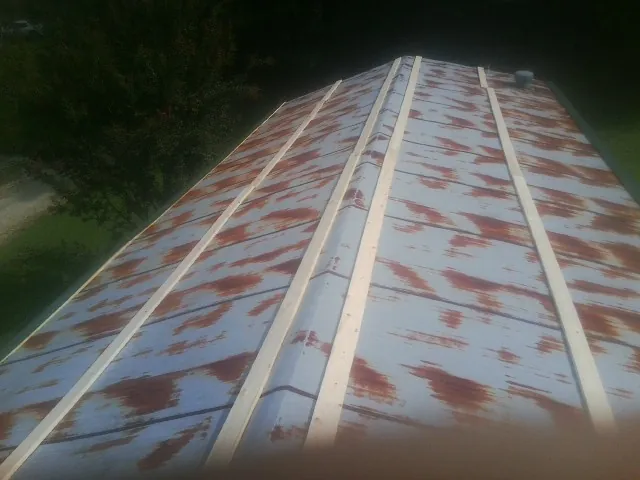 Rusted metal roof panels with new wood purlins before replacement — Storm Damage Roof Repair in Dallas by Roofing Brothers